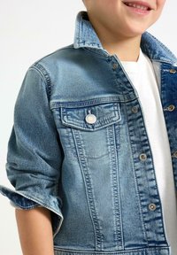 Jeansjacke in Hellblau mit hochgekrempelten Ärmeln, ausgestattet mit einer Brusttasche, Metallknöpfen und einem klassischen Kragen-Design.