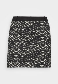 Gonna mini in bianco e nero con motivo a zebre frastagliato, tessuto liscio e vita aderente.