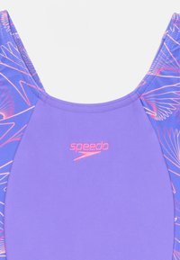 Purple swimwear featuring a stylized design on one side with pink accents. Material appears smooth with a slightly glossy finish.