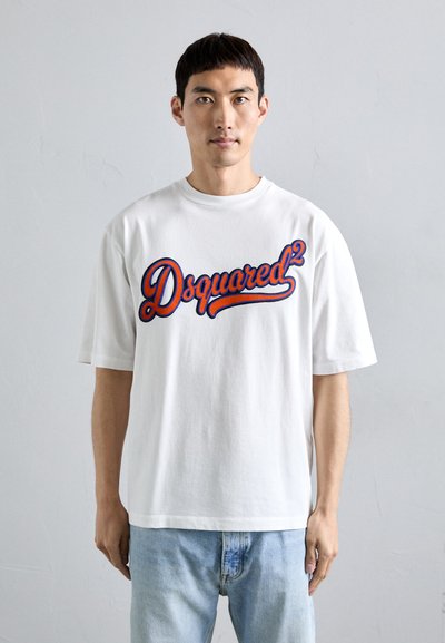 White cotton T-shirt featuring large blue and red "Dsquared²" logo across the chest. Short sleeves and relaxed fit with a smooth texture.
