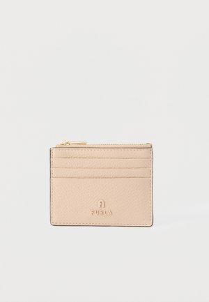 Beige leather Furla cardholder with four card slots and a top zipper pocket on a plain white background.