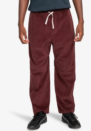 Burgundy corduroy pants with an elastic waistband and white drawstring, featuring a straight leg design and textured fabric.