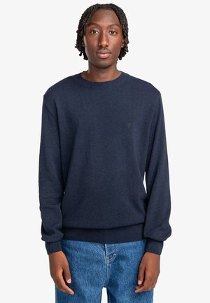 Navyblauwe pullover trui van zachte stof, met een ronde hals, lange mouwen, ribgebreide manchetten en een subtiele logo op de borst.