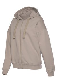 Svijetlosmeđa hoodie s patentnim zatvaračem, kapuljačom s ušicom i rebrastim manžetama s teksturiranim završetkom. Mekan, ležeran dizajn s oversized krojem.