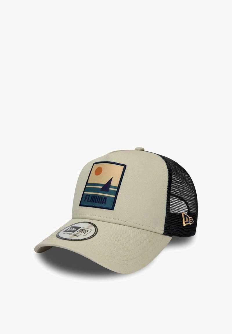 Beige cap with a black mesh back, featuring a graphic patch depicting a sun and sailboat. Adjustable strap, curved brim, and logo tag.