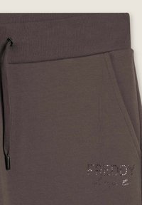 Pantalones de chándal de algodón marrón con cintura acanalada, cordón ajustable y logo "FREDDY" adornado con rhinestones.