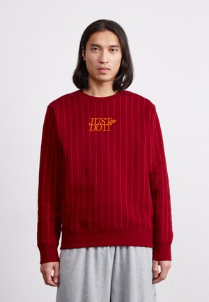 Red striped sweatshirt with ribbed cuffs and hem, featuring an embroidered "JUST DO IT" logo in yellow on the chest.