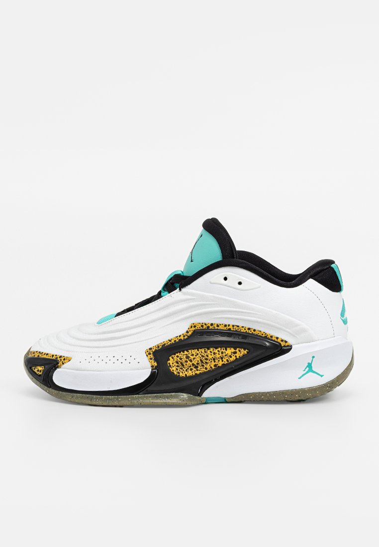 Scarpa da ginnastica bianca con accenti a pois neri e gialli, dettagli turchesi e suola texturizzata. Design aerodinamico con perforazioni.