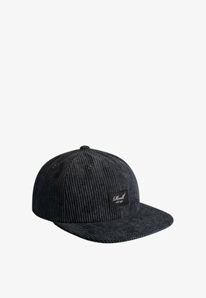 Black corduroy baseball cap with a flat brim and a small rectangular patch reading "Reell est. 1997" on the front panel.