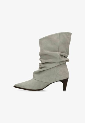 Gray suede mid-calf slouchy boot with pointed toe and low kitten heel, side view on a white background.