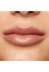 Nude matte lipstick on smooth, full lips with subtle shine. Natural texture and a soft pink-brown hue, neatly defined lip shape.