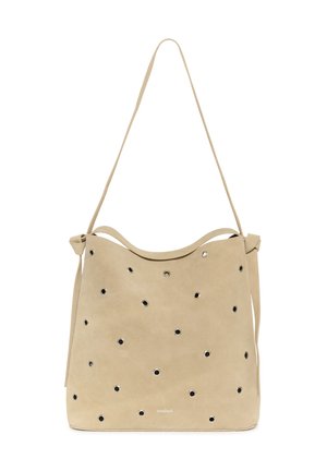 Beežist seemisnahast õlakott, millel on mitu ühtlaselt jaotunud ümmargust metallsilma ning üks pikk rihm.