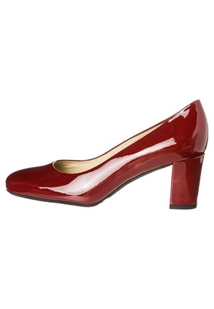 Puntti punaiset kiiltävät korkeakorkoiset kengät, joissa on pyöristetty kärki ja tukeva korko. Sisäpuolella pehmeä kultasävyinen vuori. Silkinhohtoinen, kiiltävä pinta.