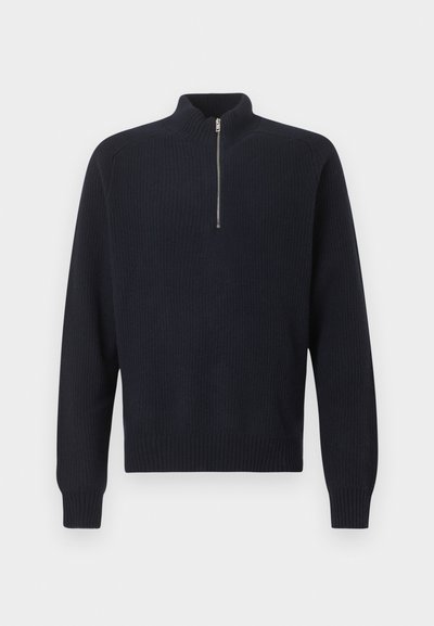 Navy ribbed sweater with a high collar and a short zipper, featuring long sleeves and a relaxed fit. Soft, textured knit material.