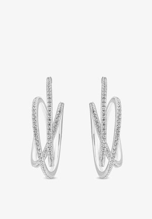 Boucles d'oreilles en argent, avec un design entrelacé et fluide. Accentué par de petites pierres précieuses transparentes le long d'un bord pour une touche de brillance.