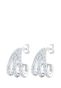 Sølvtonede øreringe med tre buede, lagdelte designs, der har klare krystaller langs kanterne. Hver ørering inkluderer en stift-baglukning.