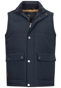 Chaleco acolchado azul marino con cierre frontal, dos bolsillos con botón a presión y un cuello forrado de forro polar. Presenta costuras sutiles y un acento de cuero.