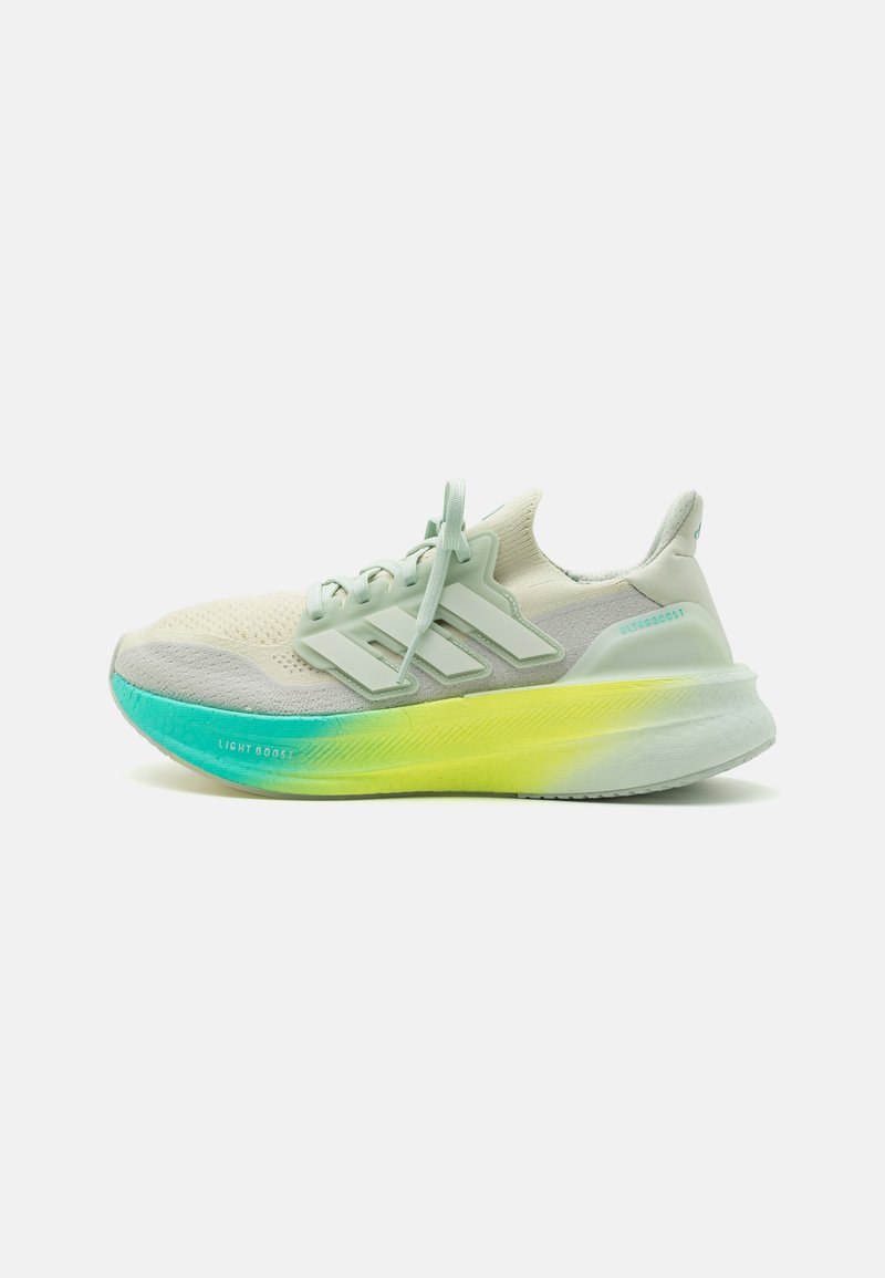 Lightweight running shoe in cream, grey, and mint green. Features knit upper, three stripe design, and a gradient sole transitioning from teal to yellow.