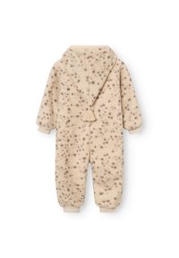 Cremfarbener Fleece-Overall mit Kapuze, der eine strukturierte Oberfläche und dunkelbraune Flecken aufweist. Rippbündchen und eine Fransenakzent.