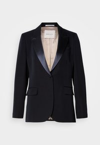 Zwarte blazer met satijnen revers, sluiting met één knoop, twee voorzakken en een beige voering. Label leest "GANT." Klassiek tailored ontwerp.