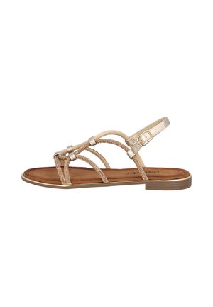 Strappy sandal with a metallic gold finish, featuring textured straps and a brown suede insole. Adjustable ankle strap with a buckle detail.