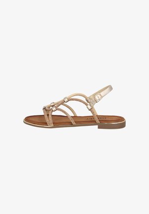 Strappy sandal with a metallic gold finish, featuring textured straps and a brown suede insole. Adjustable ankle strap with a buckle detail.