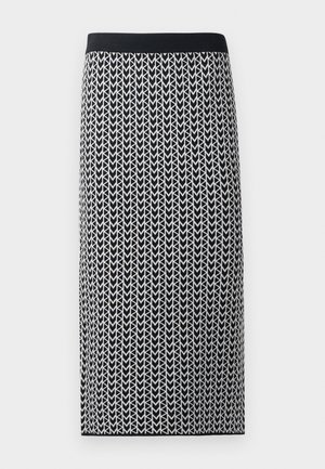 Knee-length skirt made of a stretchy knit fabric featuring a black and white arrow pattern and a black elastic waistband.
