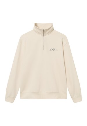 Cream-colored quarter-zip sweatshirt made of soft fabric. Features a high collar and ribbed cuffs, with "Les Deux" embroidered on the chest.