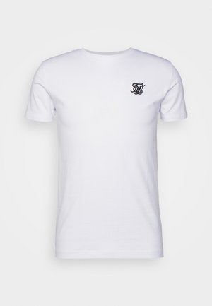 Hvit bomull T-skjorte med korte ermer og rund hals. Har en liten mørk brodert logo på venstre bryst.