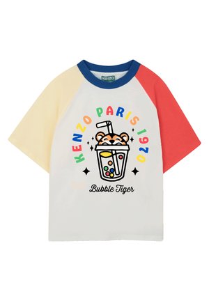 White t-shirt with raglan sleeves in yellow, red, and blue. Features a graphic of a bubble tea cup with a tiger face and text “KENZO PARIS 1970 Bubble Tiger.”