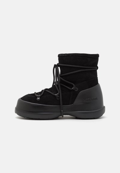 Black waterproof boots featuring a suede upper, lace-up design, curved rubber sole, and embossed branding on the heel.