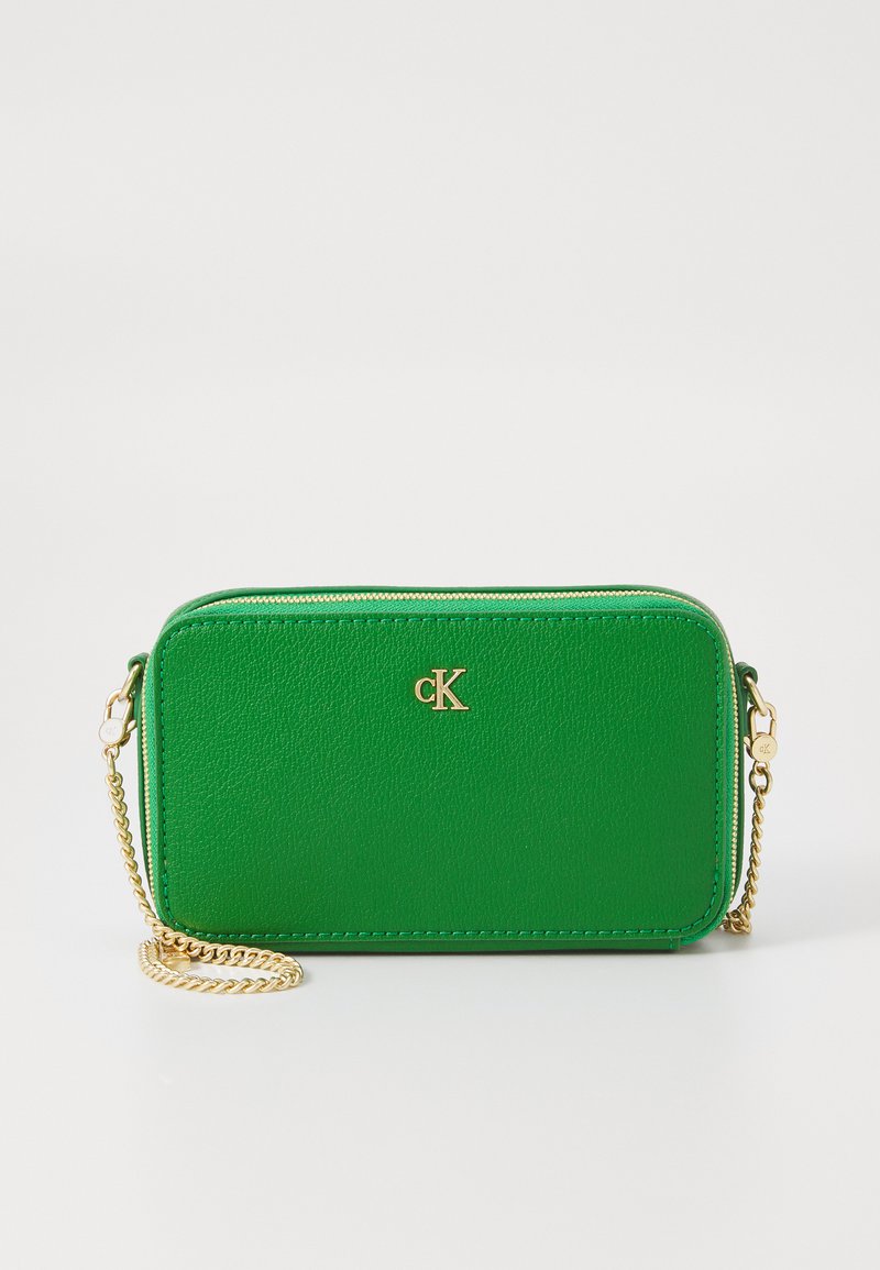 Green textured leather crossbody bag with gold hardware, featuring a zipper closure and a chain strap, embossed logo on the front.
