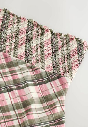 Shirred top dress featuring a pink, green, and white plaid pattern. The top has an elastic texture, and the bottom is smooth with a plaid design.