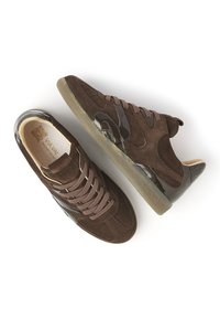 Brown suede and leather sneakers with laces, rubber soles, and branding inside and on the side, shown from top and side views on white background.