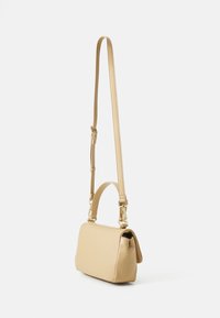 Rectangular soft beige leather handbag with a short handle and a long adjustable strap, featuring gold hardware and smooth texture.