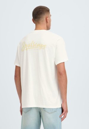 Weißes Baumwoll-T-Shirt mit einem gelben "Soulscape"-Motiv auf der Rückseite. Kurze Ärmel und eine lockere Passform mit glatter Textur.