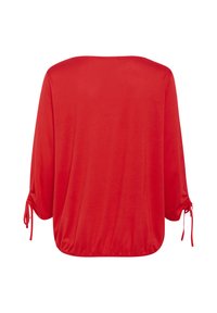 Red, loose-fitting top with three-quarter sleeves and tie details at the cuffs. Soft fabric with a rounded neckline and elastic hem.