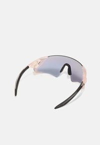 Lunettes de sport avec un design enveloppant, monture transparente rose et verres miroités dégradés passant d'un bleu clair à un bleu foncé.