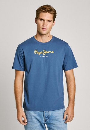 Blue cotton t-shirt featuring a round neck and short sleeves. "Pepe Jeans London" logo in yellow across the chest. Casual fit.