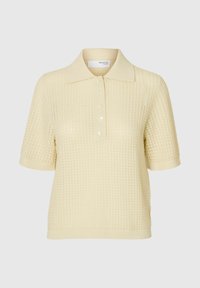 Polo shirt tricoté jaune clair avec un col, des manches courtes et cinq boutons à l'avant. Tissu texturé avec un motif à carreaux.