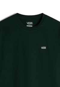 T-shirt Vans noir coupe ample en taille moyenne avec petit logo Vans blanc sur la poitrine gauche.