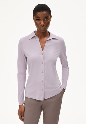 Lavender long-sleeve shirt with a collar, button-down front, and smooth texture. Paired with light brown pants.