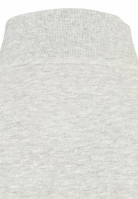 Col roulé tricoté doux gris clair avec une texture côtelée subtile, présenté en gros plan.