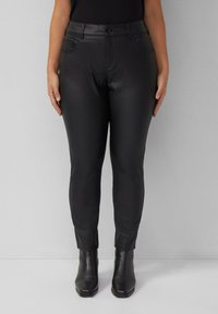 Must mustrõngast nahast püksid, millel on slim fit, viie taskuga disain ja pahkluuni ulatuv lõige, koos mustade kontsakatega saapadega. Sile tekstuur.