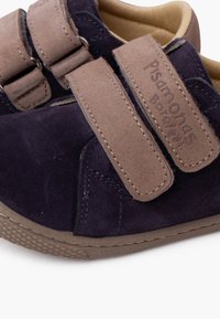 Dark blue suede shoes with light brown velcro straps. Features rounded shape and textured rubber sole with a slight pattern for grip.