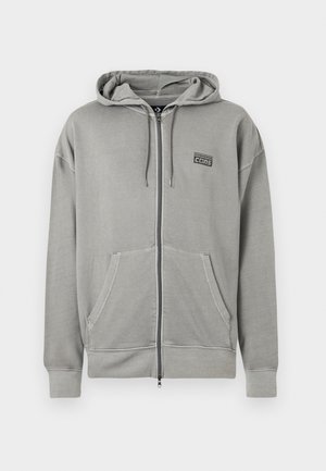 Heleroheline tõmblukkuga dressipluus esitaskute, nööriga kapuutsi ja väikese musta Converse CONS logoga vasakul rinnal.