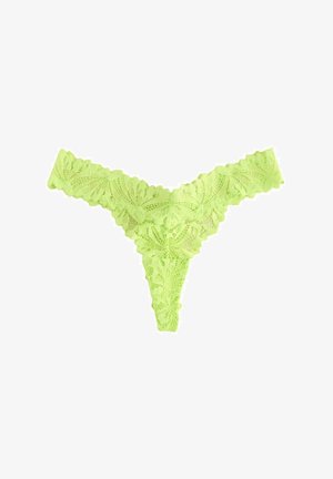 String en dentelle de couleur vert lime vif, avec un motif floral et des bords festonnés. Tissu extensible, conçu pour une couverture minimale.