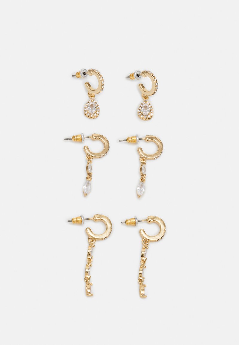 Gold-tone earrings featuring two pairs with clear crystals; one pair has a teardrop design, another with chain accents and faceted shapes.