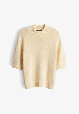 Pull tricot à manches courtes de couleur crème avec un col rond côtelé épais et des poignets et un ourlet côtelés, présenté sur un fond blanc.