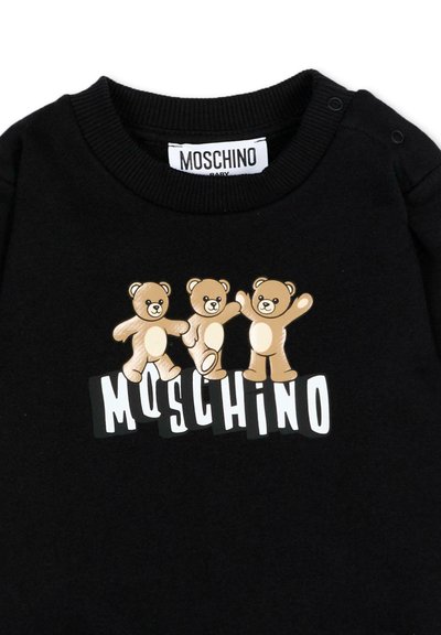 Pull noir pour bébé avec trois oursons marron clair au-dessus de l'inscription Moschino en lettres blanches audacieuses sur le devant.
